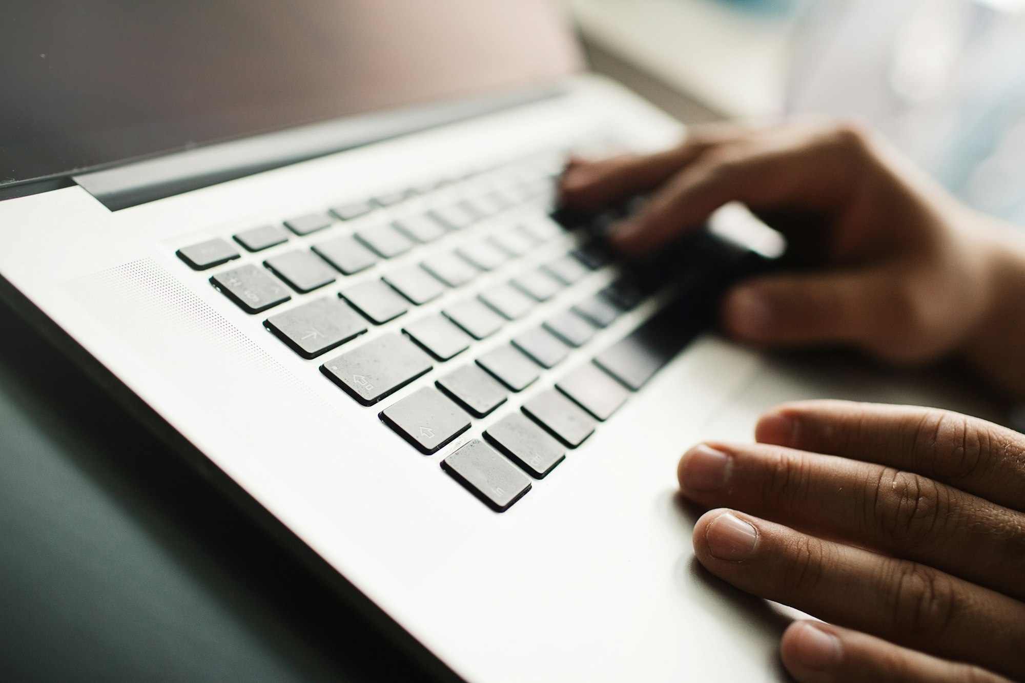 Mans hands on laptop. Business man work on computer